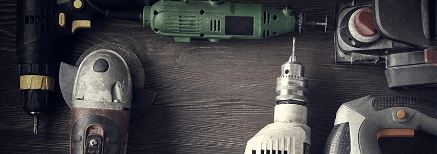 Power tools on a dark wood surface